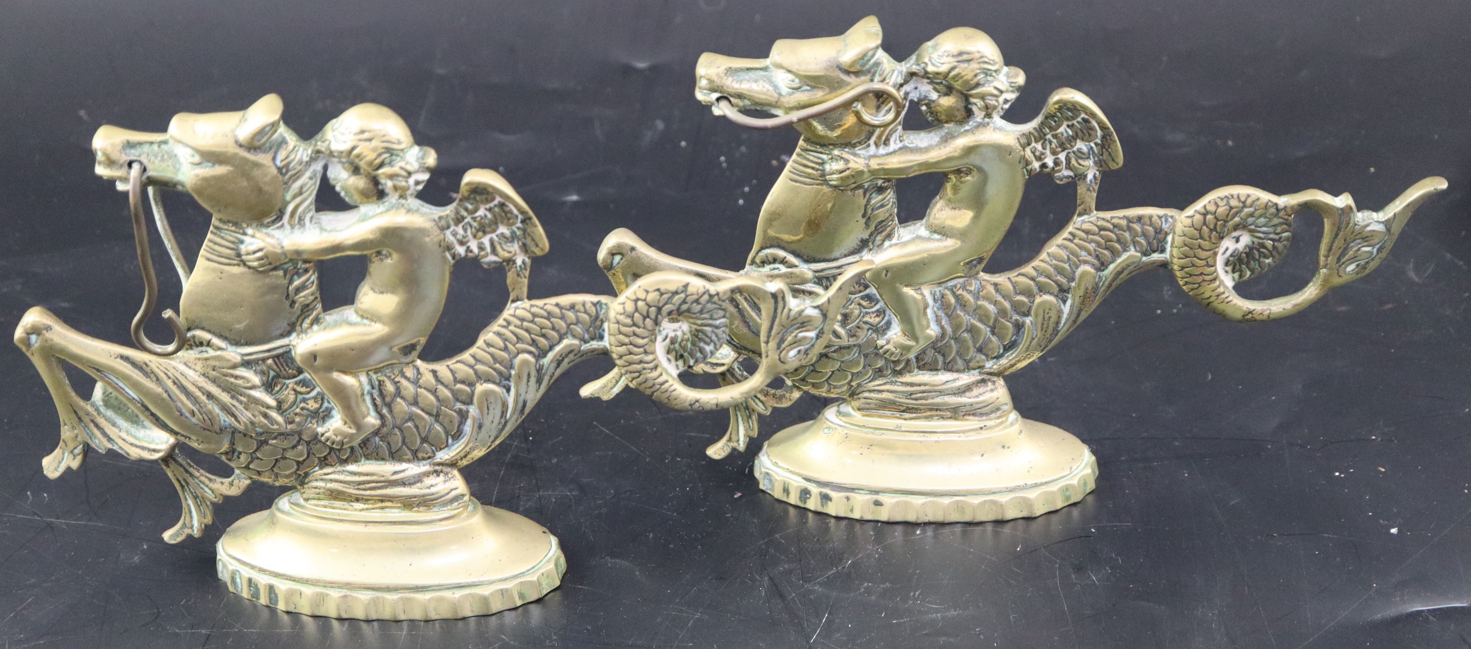 A pair of Venetian brass door stops, width 25cm height 15.5cm